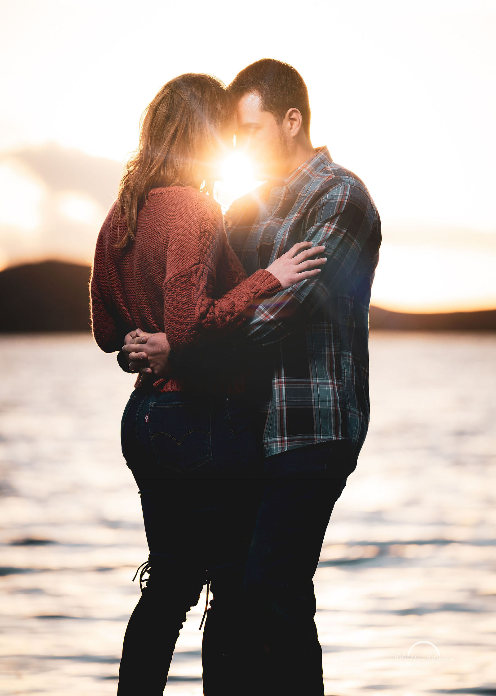 Engagement portrait at golden hour by the lake