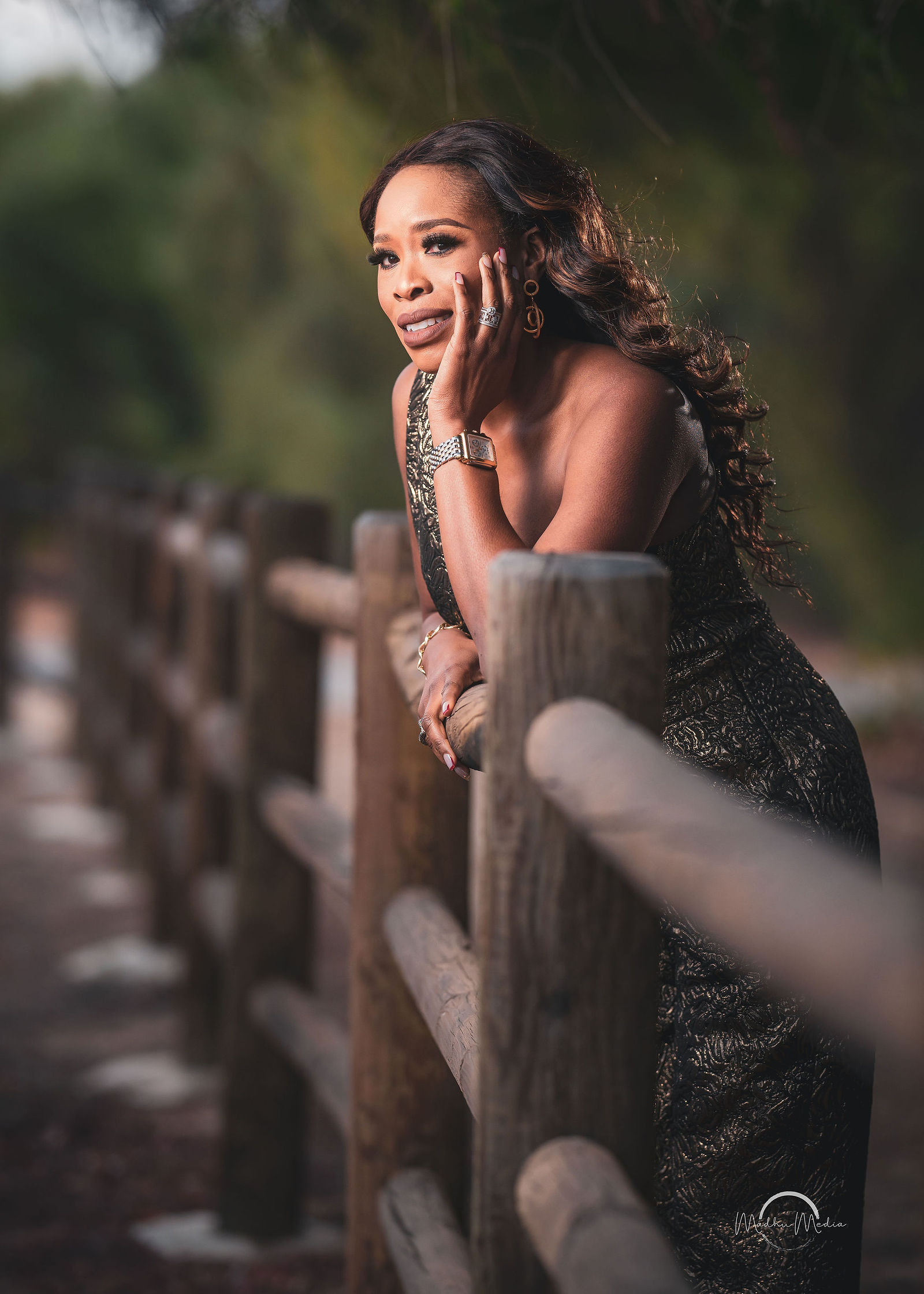 Evening portrait in a brocade gown along the rail fence
