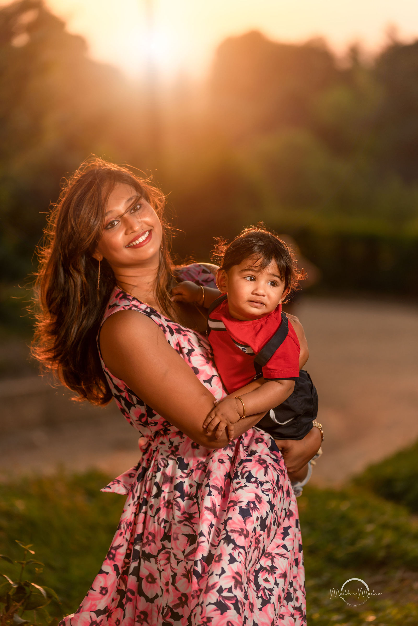 Mom and her baby boy glowing in the sunset