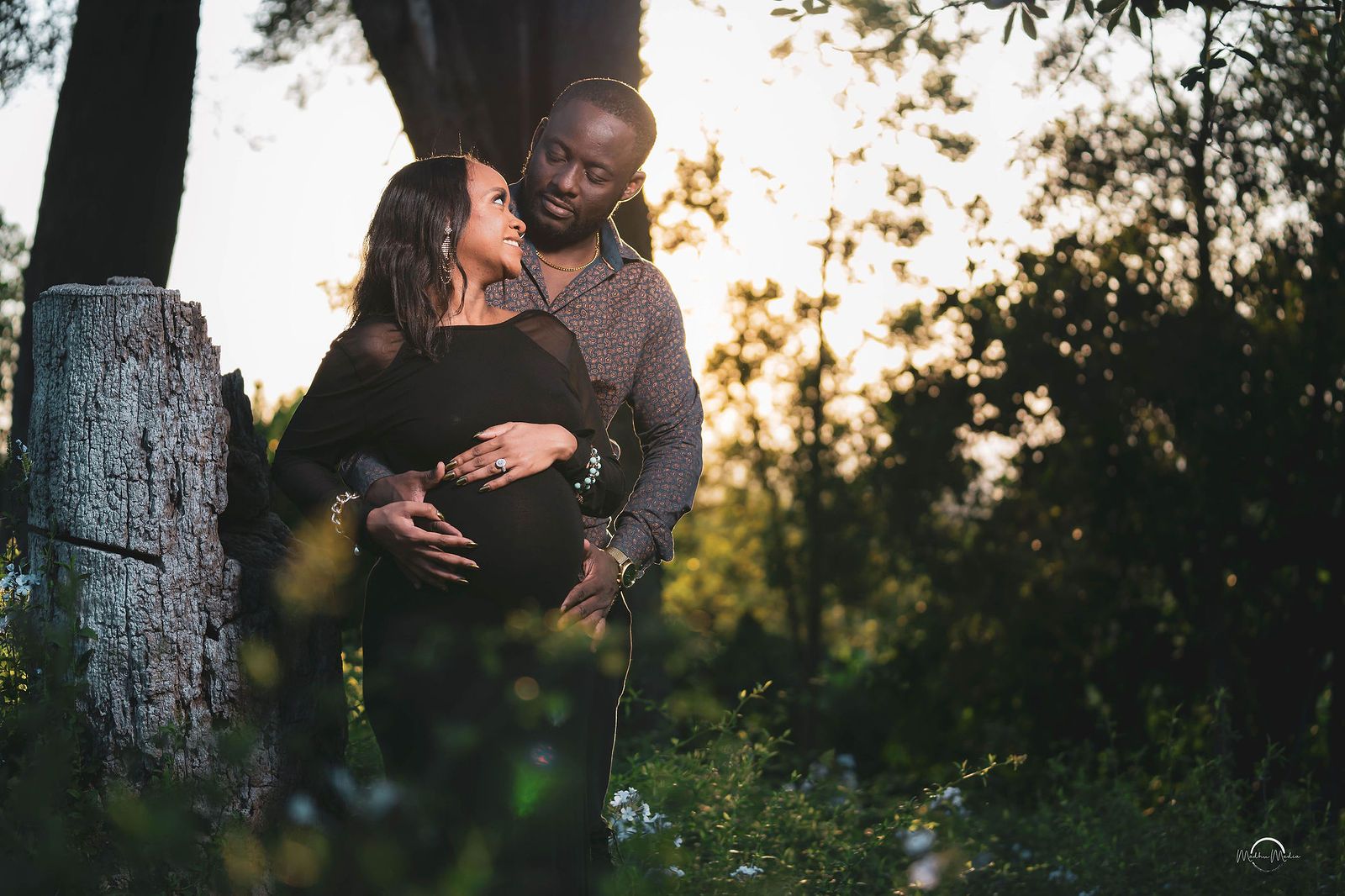 Couple embracing lakeside at dusk